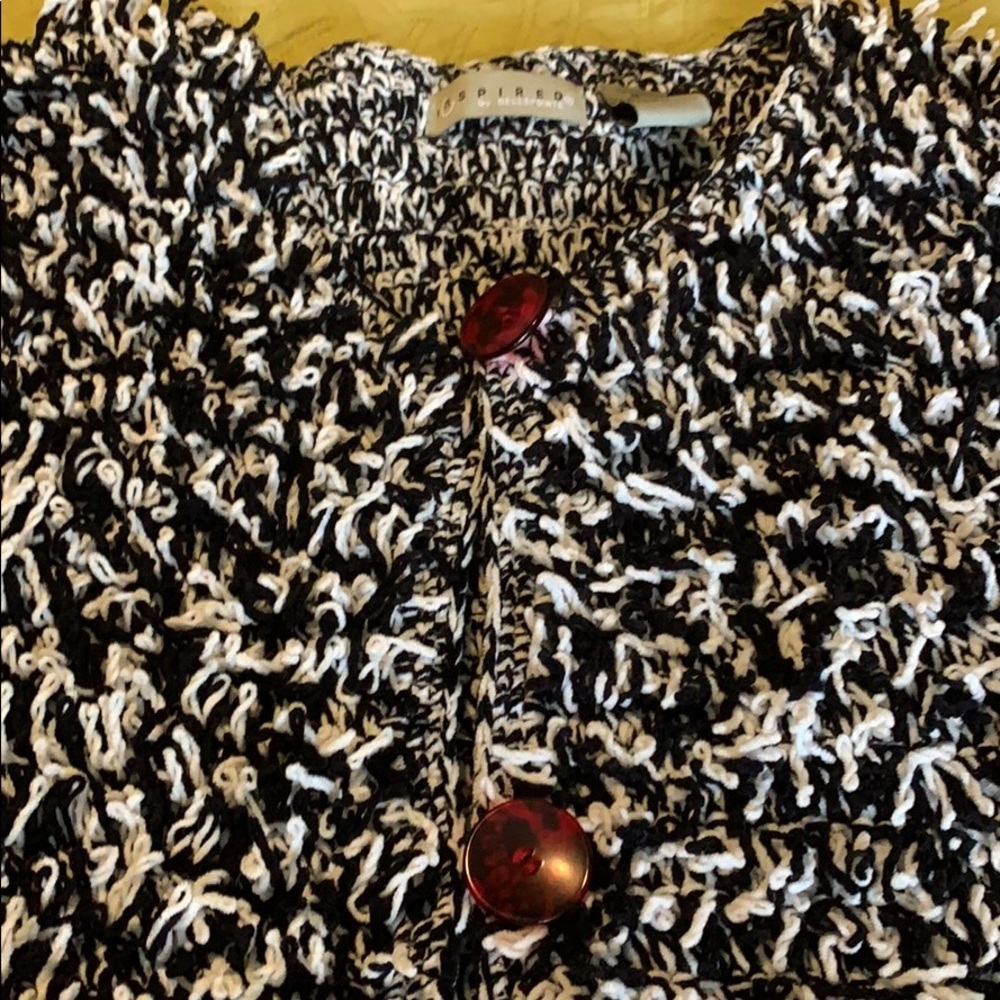 Black and white jacket. Red buttons.  Medium, heavy weight, very cozy!